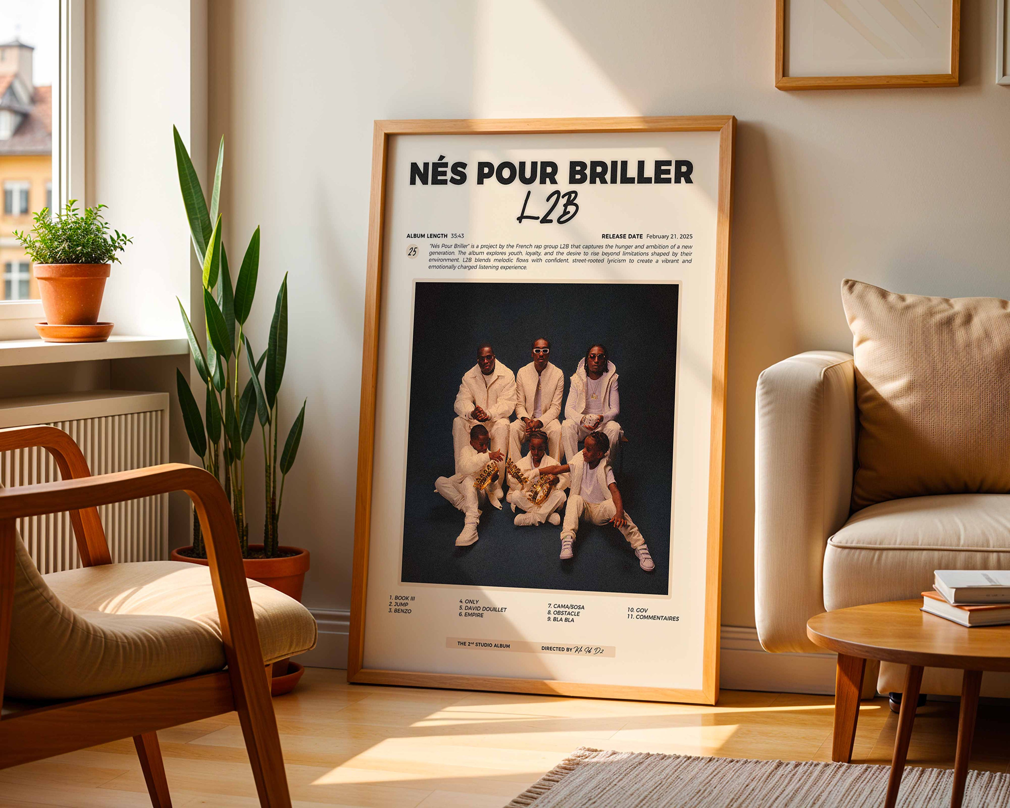 Poster minimaliste encadré de l'album de L2B posé contre un mur dans un salon lumineux, art mural contemporain.